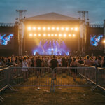 Temporary barriers used to manage crowds at an outdoor concert, ensuring safety and organization during a large-scale event.