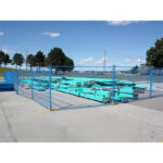 Temporary fence panels enclosing a construction site with blue borders.