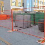 Orange temporary fence panels in an outdoor setting, demonstrating versatility for various projects.