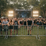 A music festival scene with crowd fencing in place, creating a safe area for concertgoers in front of the stage while managing the large crowd.