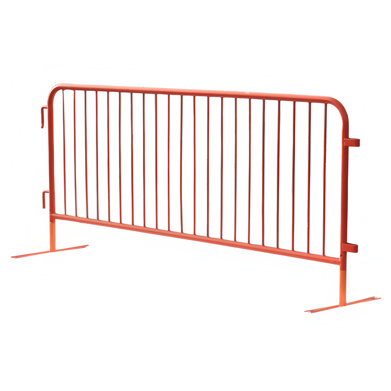 A red metal safety barrier with vertical bars, designed to control crowds and define boundaries at events.