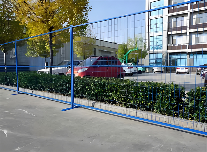 Blue powder-coated temporary construction fence in a Canadian urban setting, highlighting the use of durable materials and compliance with height and opening regulations for construction site safety.