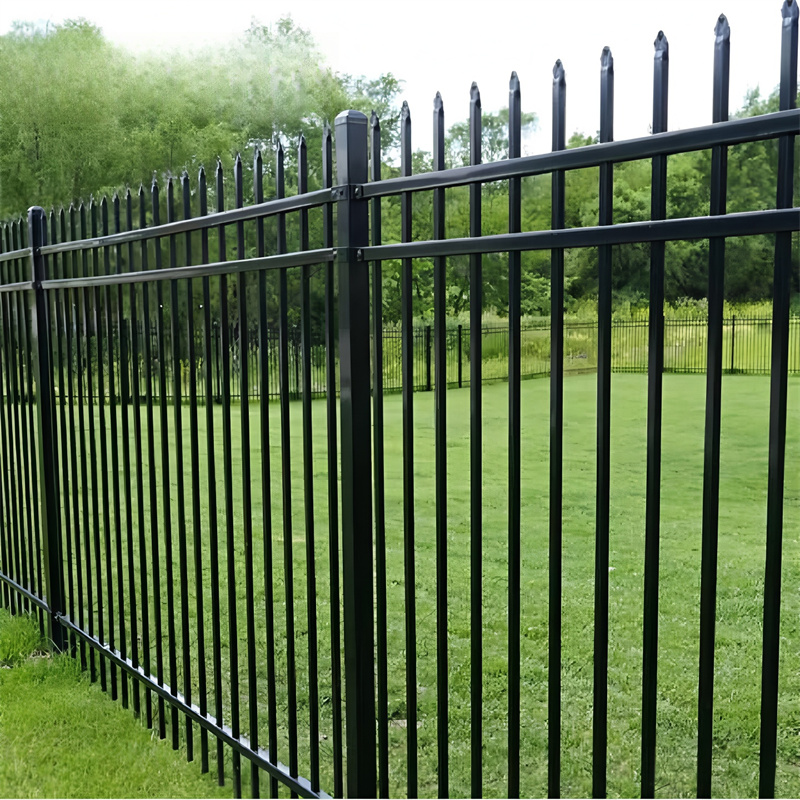 Custom black steel fence surrounding a well-maintained lawn, demonstrating elegance and durability.