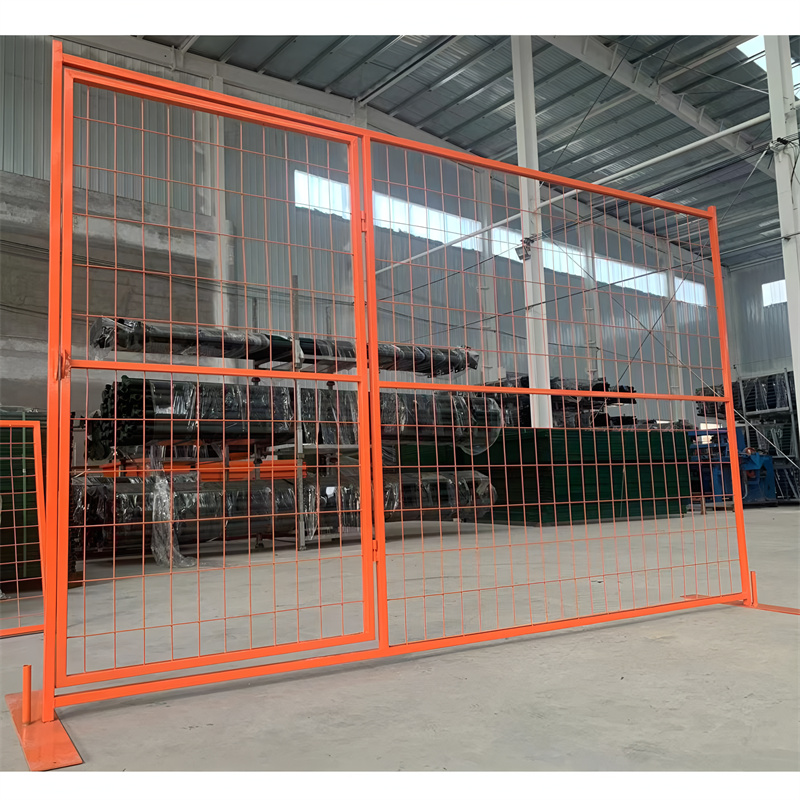 An orange construction fence with a gate, located indoors in a factory, surrounded by stored materials and equipment, emphasizing its functionality.