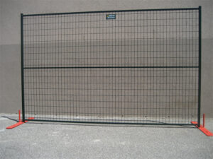 A single black temporary fence panel with orange flat bases, positioned against a plain light gray wall.