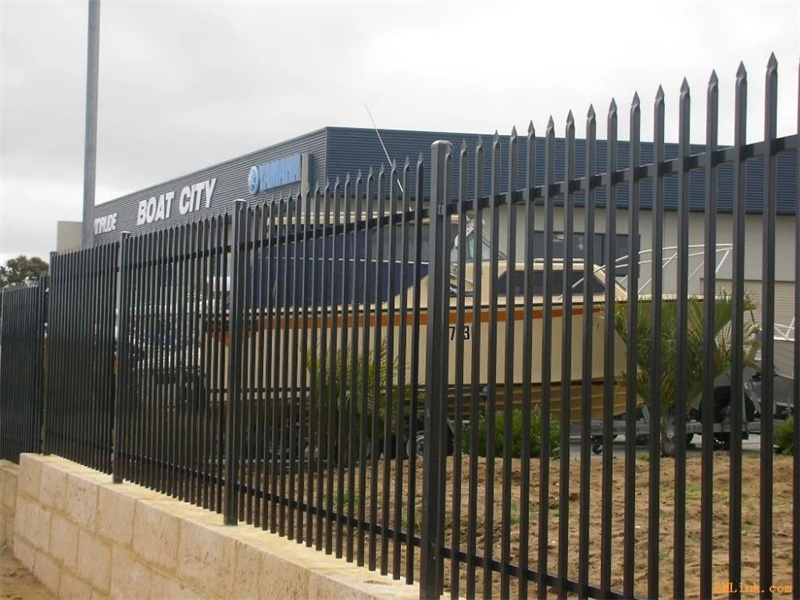 A black steel picket fence with spear tops providing security for a commercial property after being successfully imported and installed.