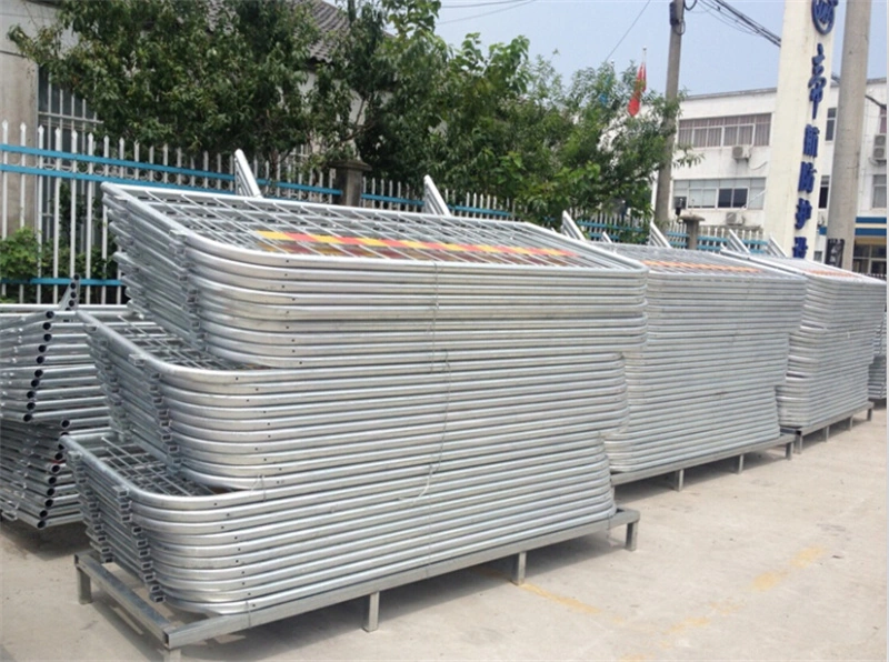 Stacks of galvanized temporary crowd control barriers manufactured by DB Fencing, an Anping-based wire mesh specialist with 14 years of export experience, featuring hot-dipped galvanized finishes for durability in outdoor environments like construction sites and events.