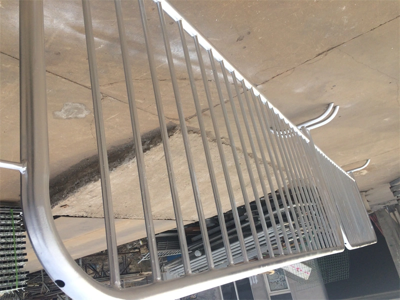 Close-up of DB Fencings galvanized temporary crowd control barrier featuring vertical metal bars, curved top rail, and custom plastic feetdesigned for construction sites and events, meeting AS 4687 standards.