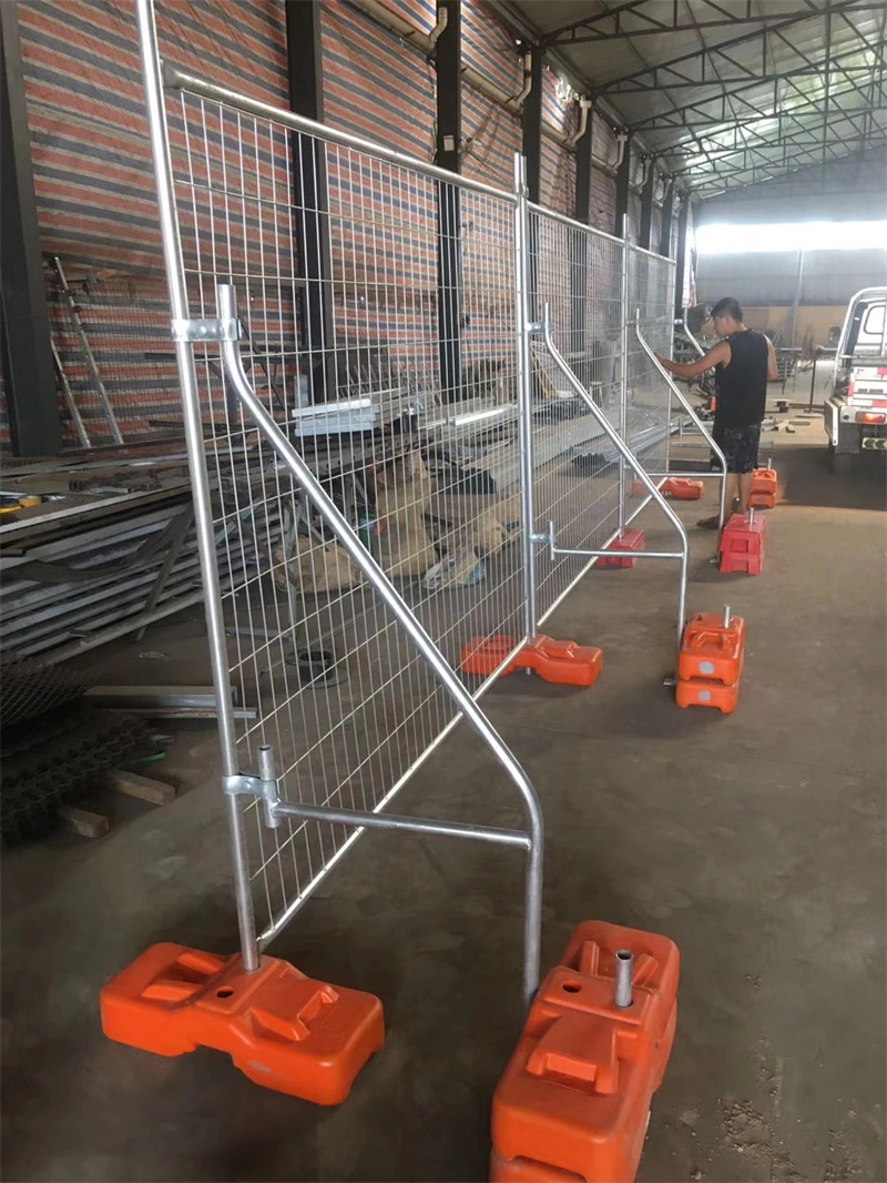DB Fencing's temporary galvanized metal fence panels with custom orange plastic feet, manufactured in their Anping facility, designed for construction sites and event crowd control applications.