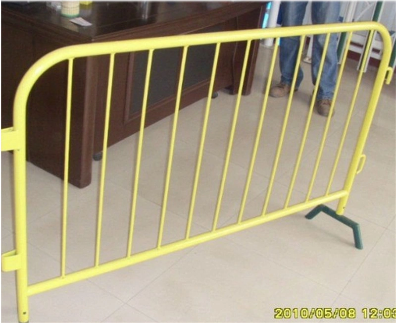 A yellow metal crowd control barrier with custom green plastic feet, manufactured by DB Fencingan Anping-based wire mesh fence leader specializing in durable, AS4687-compliant barriers for event management and construction firms.