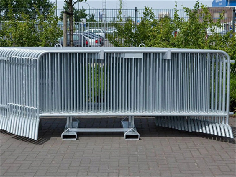 A high-quality galvanized crowd control barrier with custom plastic feet, produced by DB Fencing, ideal for event crowd control and construction site security.