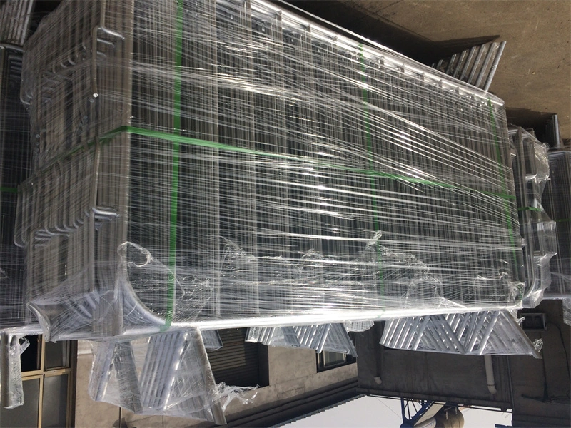 Stack of galvanized wire mesh crowd control barriers wrapped in clear plastic shrink wrap with green straps, ready for exportmanufactured by DB Fencing, a leading one-stop wire mesh fence supplier with 14 years of export experience.