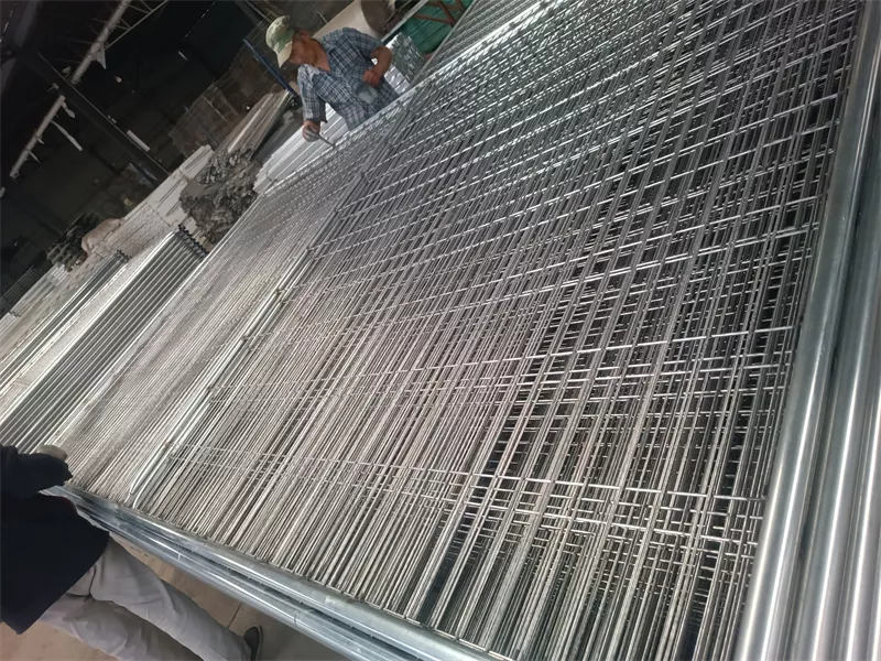 Galvanized welded wire mesh temporary fence panels produced in DB Fencing's Anping factory, featuring durable hot-dipped galvanized finish for outdoor use, with workers overseeing quality control in a high-capacity manufacturing environment.
