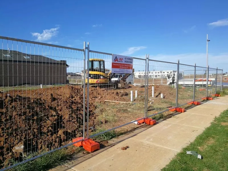 DB Fencing's temporary metal mesh fence with specialized plastic feet installed at a construction site, showcasing durability and compliance for Australian construction projects.