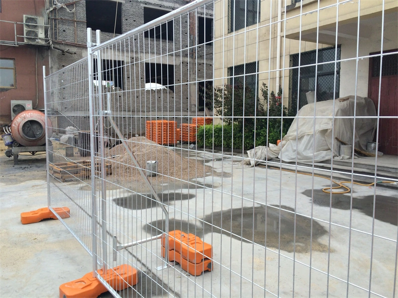 DB Fencing's temporary metal fence with durable plastic feet installed at a construction site, showcasing our hot-dipped galvanized finish and specialized manufacturing for construction firms and event management companies.