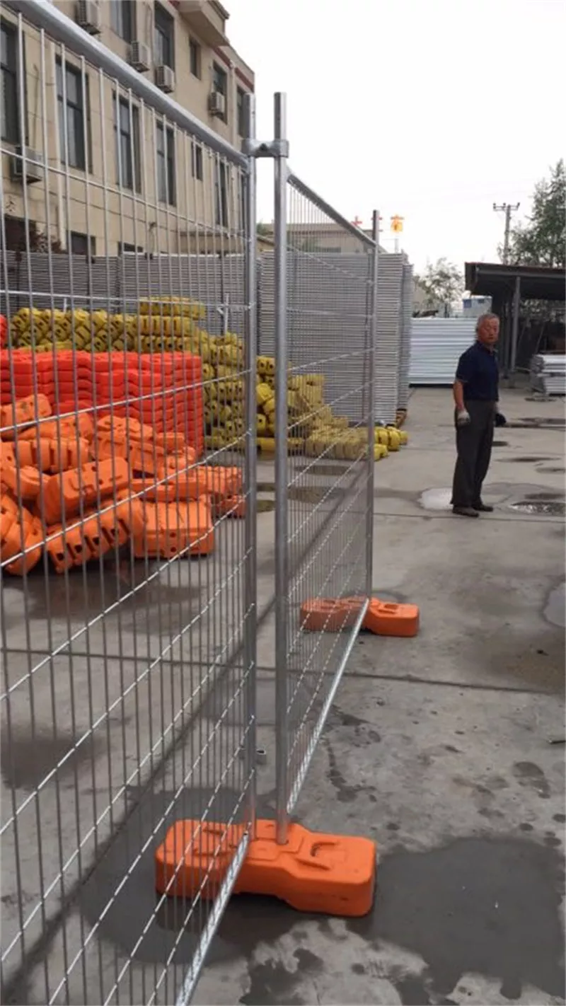 Temporary metal fence with orange plastic feet (produced using DB Fencing's in-house plastic feet machine) displayed at their Anping facility, highlighting their durable, compliant temporary fencing solutions for construction and event management clients.