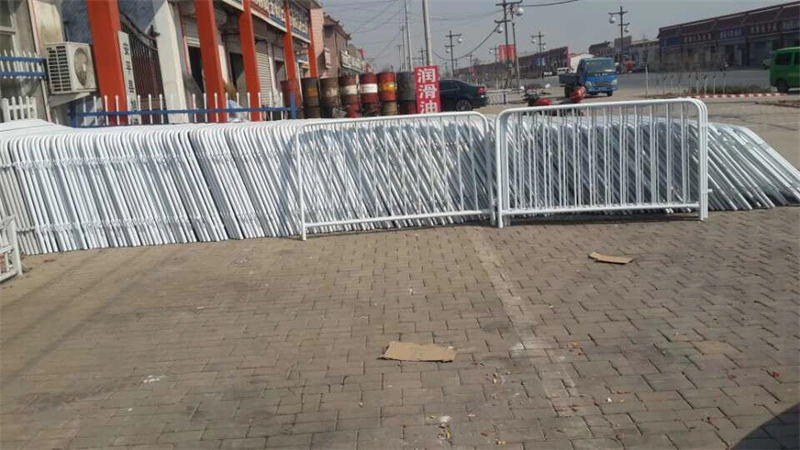 Stack of white temporary crowd control barriers from DB Fencing, a leading wire mesh manufacturer, designed for event management and construction site security with durable powder-coated finishes.