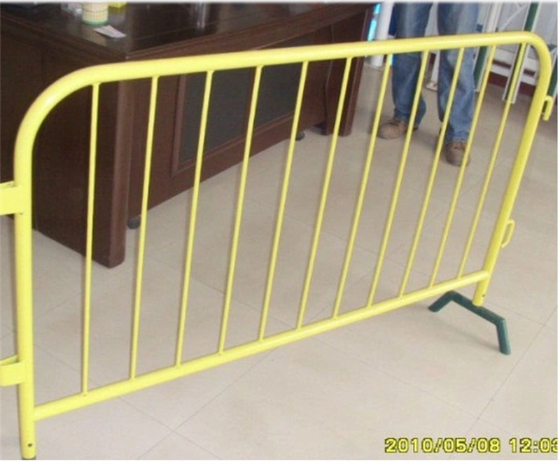 A yellow metal crowd control barrier with green plastic feet, manufactured by DB Fencinga leading wire mesh fence supplier with 14 years of export experience and in-house plastic feet production for enhanced durability and customization.