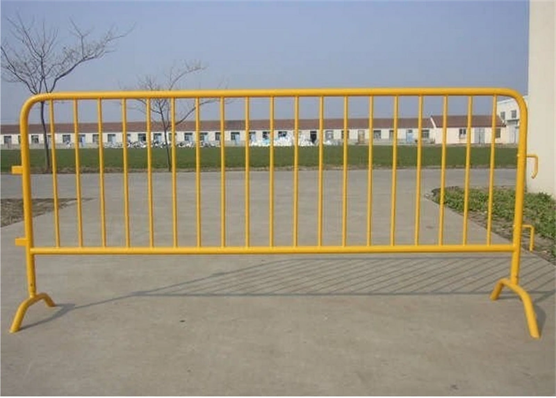 Bright yellow temporary metal crowd control barrier with vertical bars and curved stability feet, manufactured by DB Fencinga leading wire mesh fence supplier with 14 years of export experience, designed to meet AS4687 standards for construction sites and event crowd management.