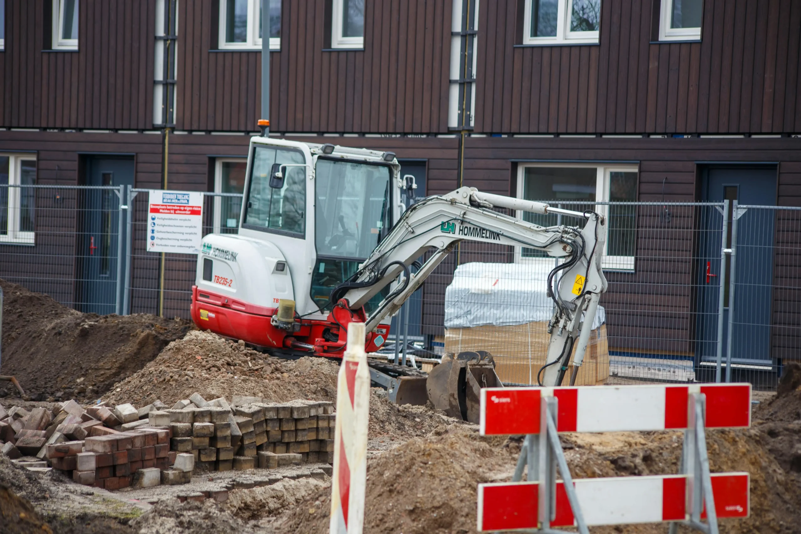 excavator filling Hesco wall barriers