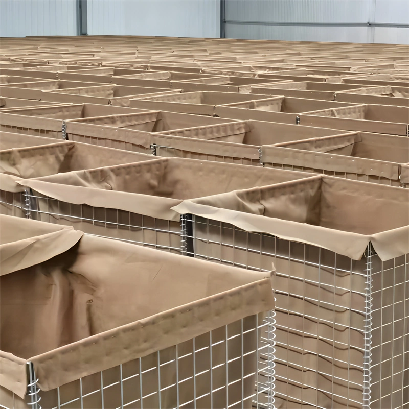 Rows of factory-produced Hesco barriers with galvanized steel mesh and heavy-duty linen sleeves, manufactured by DB Fencing. This image illustrates our production capacity for high-volume temporary security and flood defense solutions.