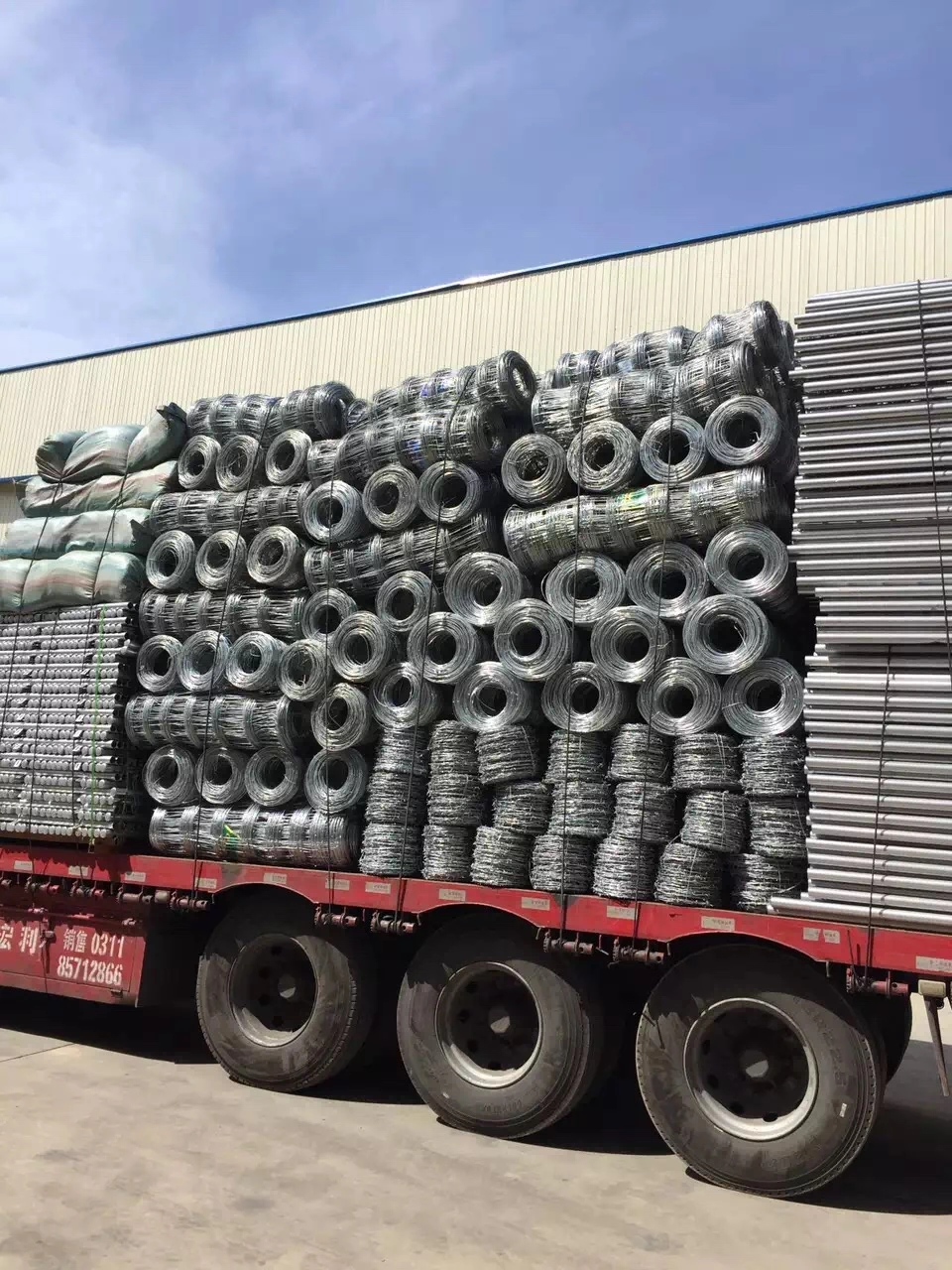 Anping Deban Metal Wire Mesh Products Co., Ltd shipping factory-direct galvanized wire coils for Hesco Barriers. This heavy-load transport demonstrates our capacity for high-volume B2B orders and secure logistics for international clients.