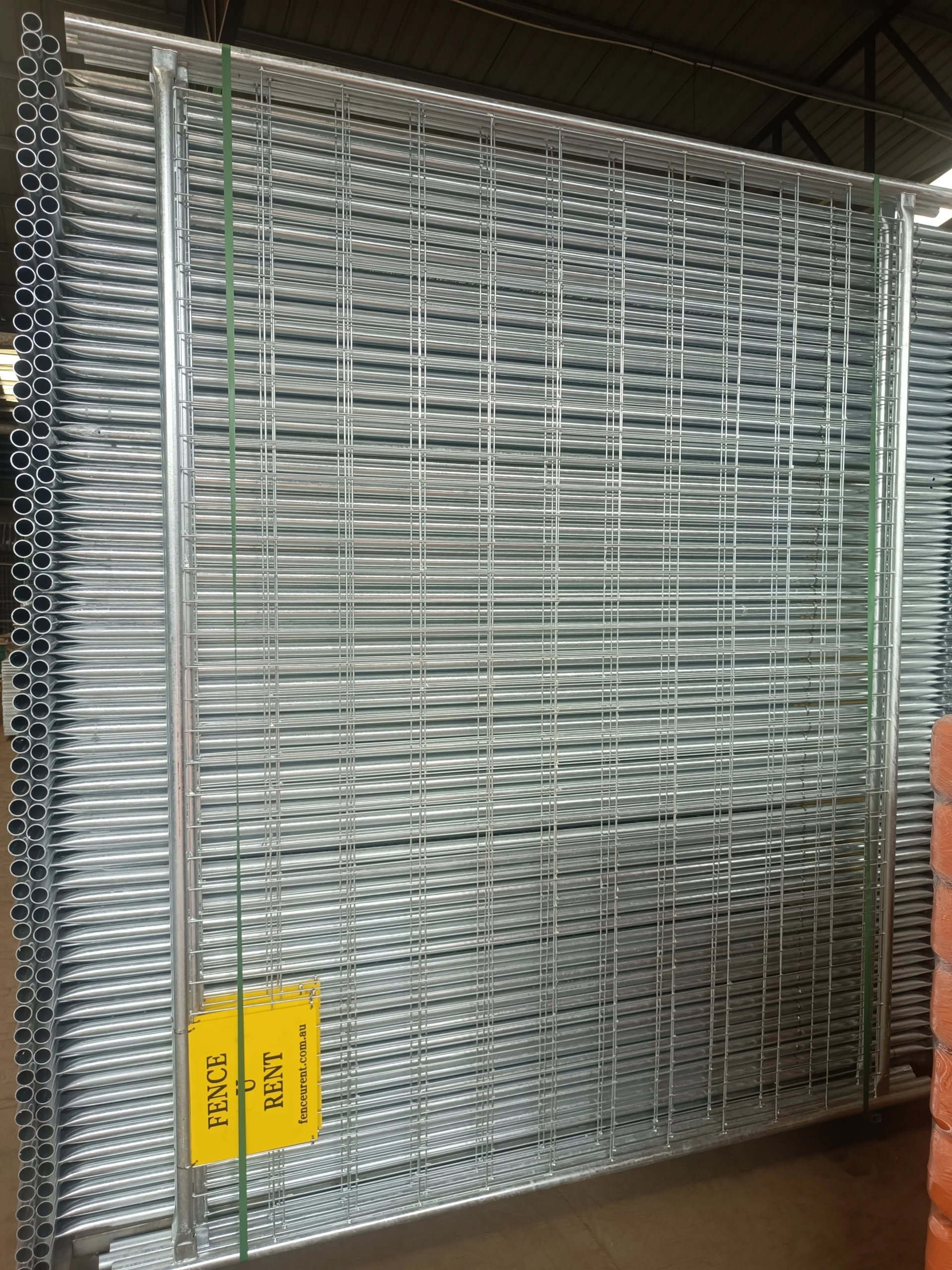 A large inventory of hot-dipped galvanized temporary fencing systems for construction, manufactured by DB Fencing (Anping Deban Metal Wire Mesh Products Co., Ltd) and ready for export to Australia. These panels meet AS 4687 standards, providing essential site security for construction and civil engineering firms.