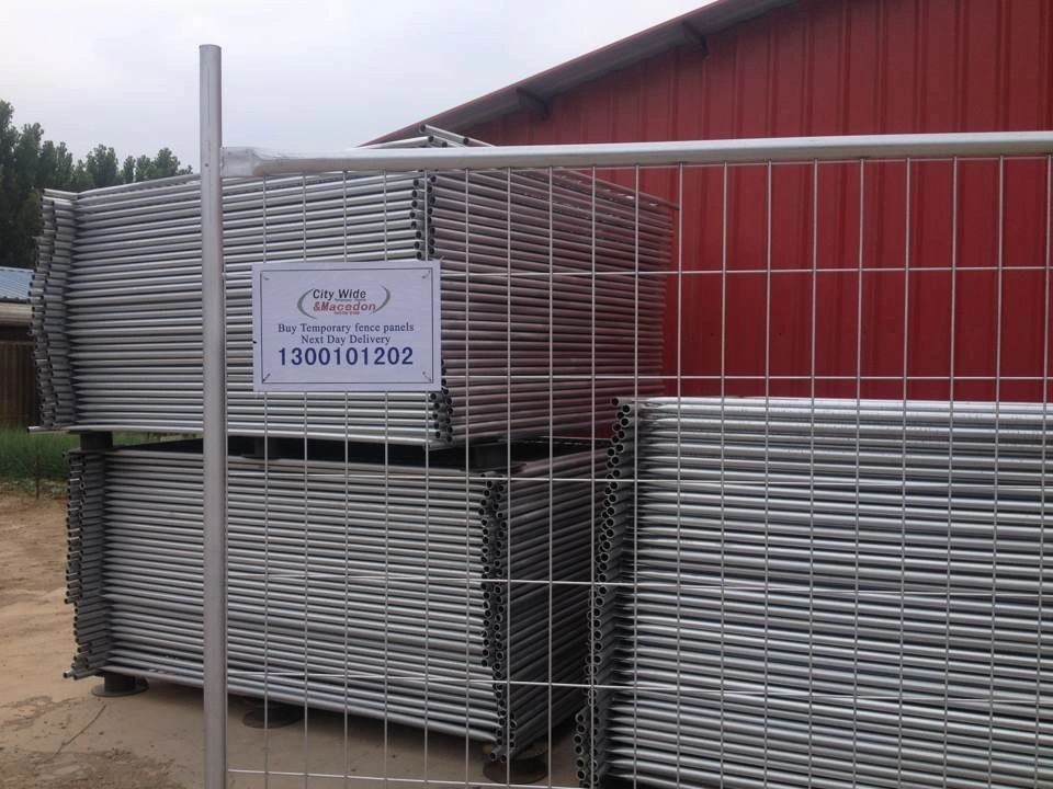 Stacks of hot-dipped galvanized temporary fencing panels, produced by Anping Deban Metal Wire Mesh Products Co., Ltd (DB Fencing), ready for bulk export. These durable Temporary Fencing Systems for Construction Sites are designed to meet Australian Standard AS 4687-2022 and are ideal for securing project sites.