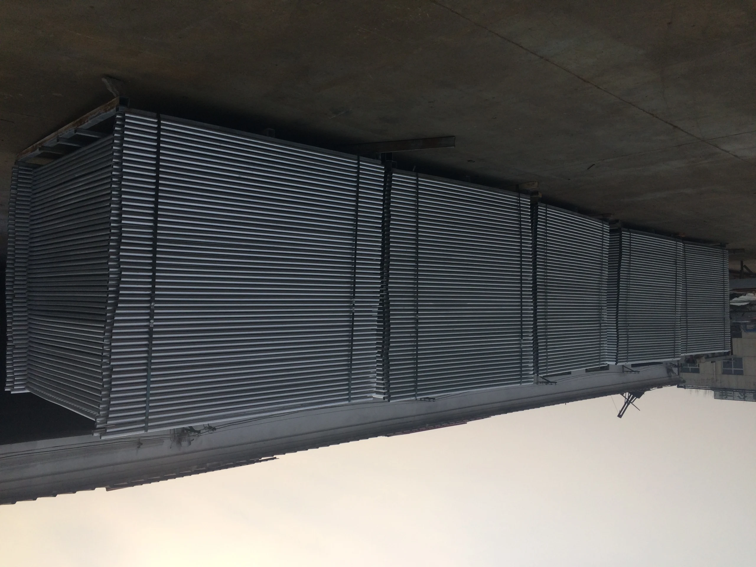 Massive stacks of newly manufactured, hot-dipped galvanized steel frames, produced by Anping Deban Metal Wire Mesh Products Co., Ltd (DB Fencing), destined for high-quality Temporary Fencing Systems for Construction Sites. These durable panels are engineered to meet strict Australian compliance standards for site security and event perimeter solutions across global markets.