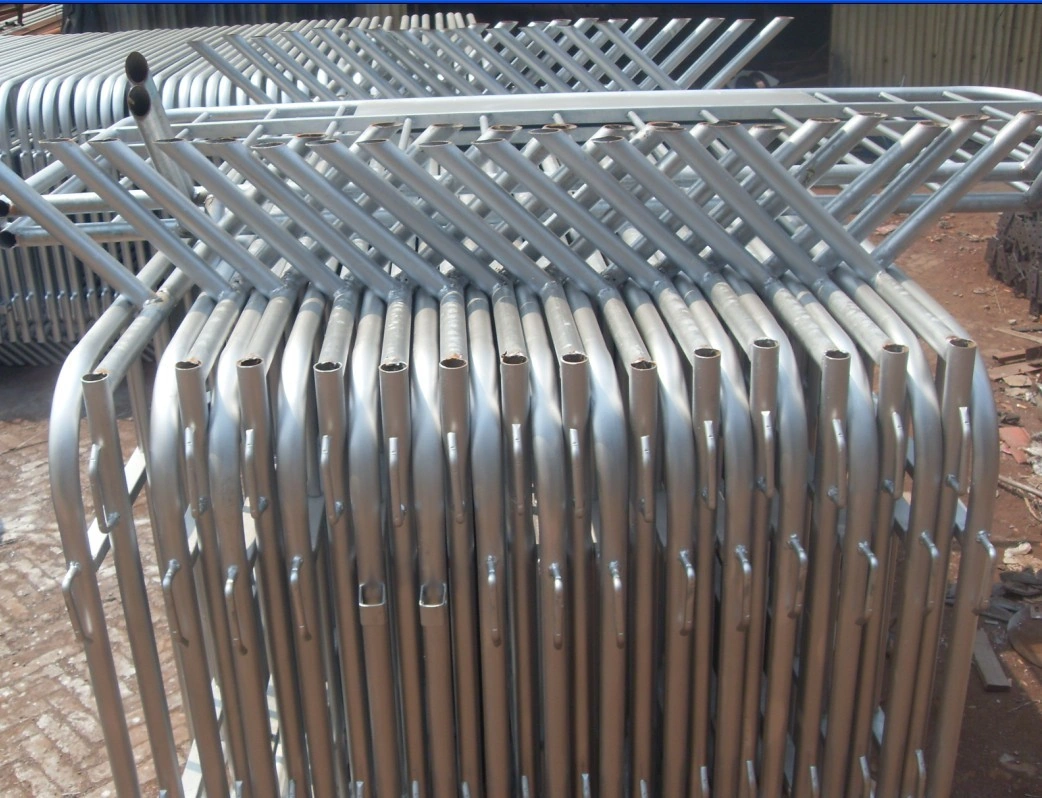 A large stack of hot-dipped galvanized tubular steel crowd control barriers, showcasing DB Fencing's high-capacity production for robust event and public safety solutions. These export-ready barriers, manufactured in Anping to withstand harsh outdoor environments, meet strict quality standards for global distributors and event management companies.