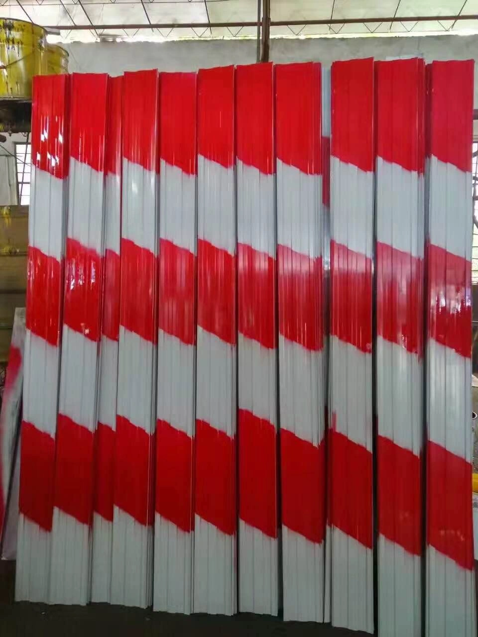 Rows of DB Fencing's premium red and white diagonally striped steel crowd control barrier panels, showcasing superior visibility and robust construction. These durable components are manufactured by Anping Deban Metal Wire Mesh Products Co., Ltd for effective event perimeter management and temporary safety solutions, meeting global standards for Crowd Control Barriers.