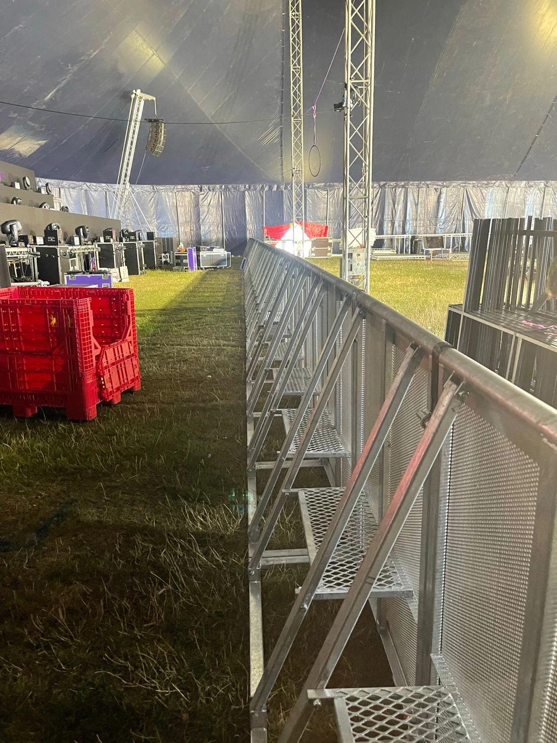 An interior view of a large event marquee showcasing DB Fencing's robust steel crowd control barriers effectively separating areas, designed for optimal public safety and event perimeter management. These durable barriers, ideal for event management companies, demonstrate our commitment to quality products meeting international standards for festivals and public gatherings.