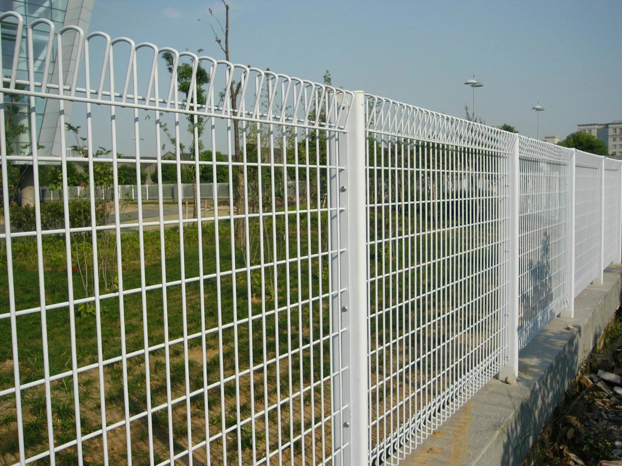 A visually striking white BRC (Roll Top) welded wire mesh fence, showcasing DB Fencing's expertise in providing durable Steel Security Fencing for Permanent Perimeter Solutions. This high-quality fence, perfect for commercial, industrial, and public areas, highlights our commitment to compliance and robust outdoor performance.