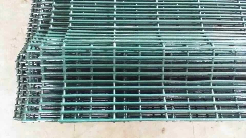 Stacked green PVC-coated steel security fencing panels manufactured by DB Fencing, featuring durable welded wire mesh for industrial perimeter safety.