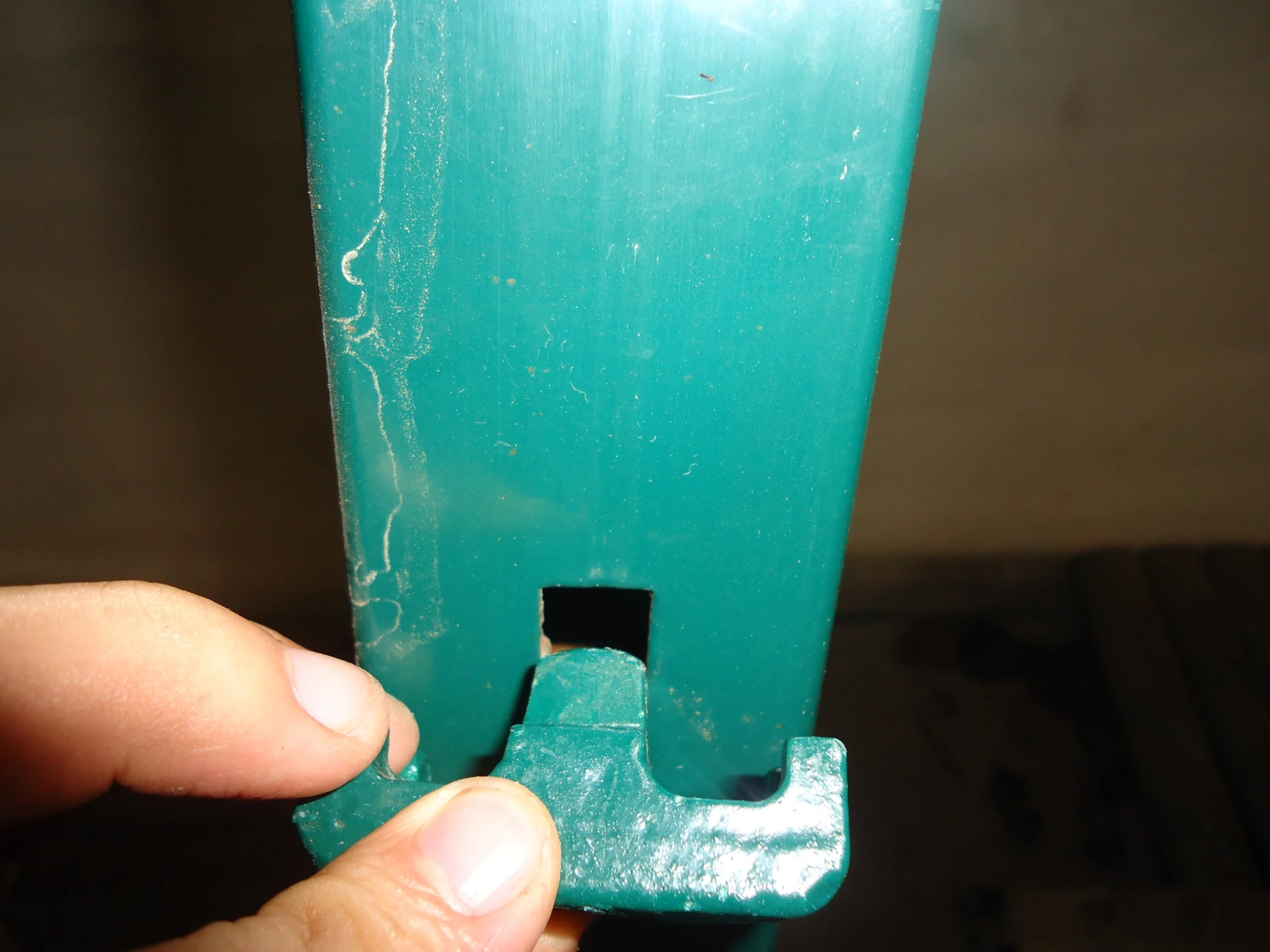Close-up view of a powder-coated green temporary fence foot manufactured by Anping Deban Metal Wire Mesh Products Co., Ltd, ensuring stability for construction and crowd control applications.