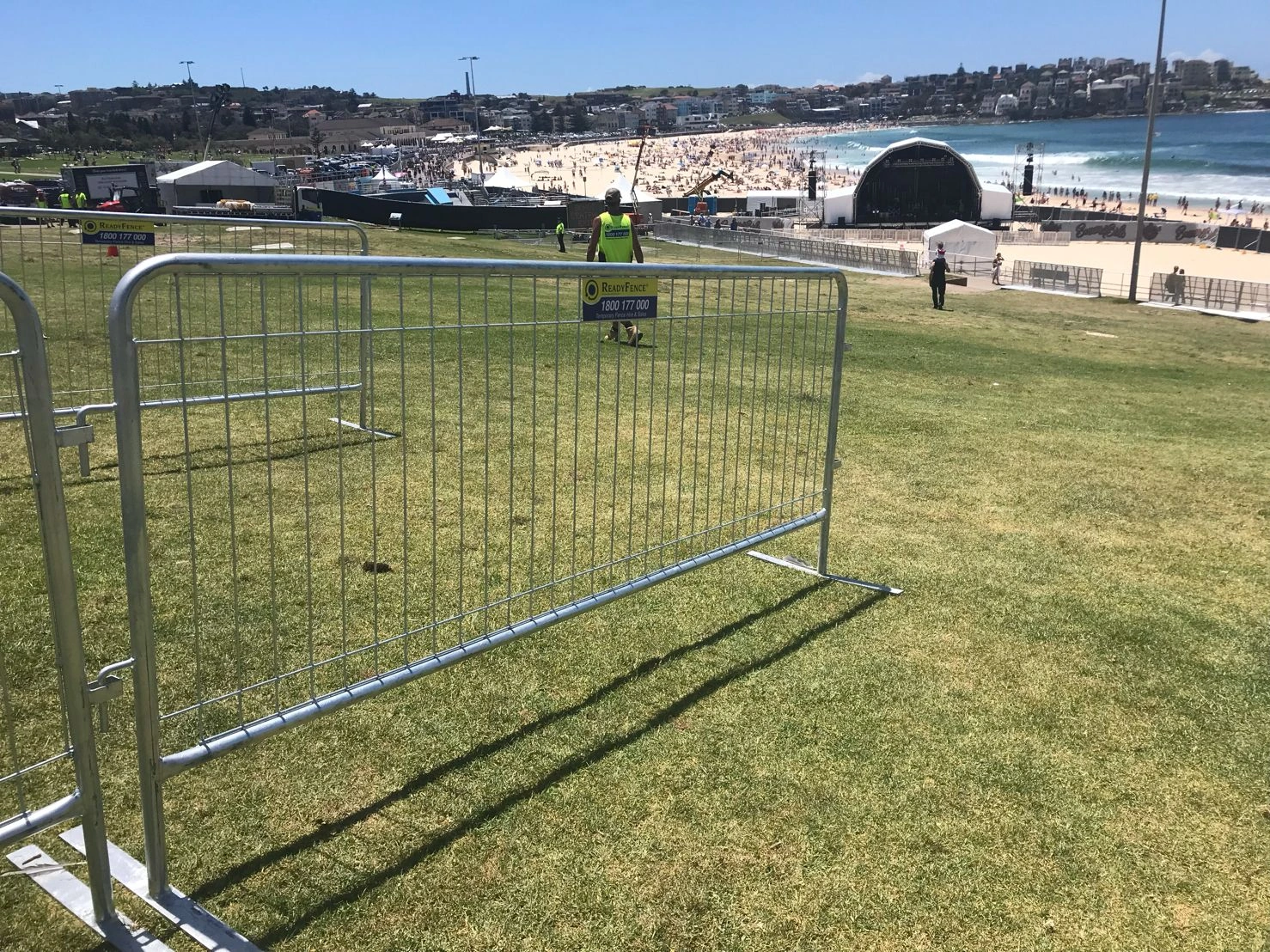DB Fencing supplies heavy-duty galvanized steel crowd control barriers for events, showcasing our durable products managing perimeters at a vibrant beach festival. These temporary event fences, meeting Australian standards, offer reliable crowd management solutions for event organizers and ensure public safety in outdoor environments.