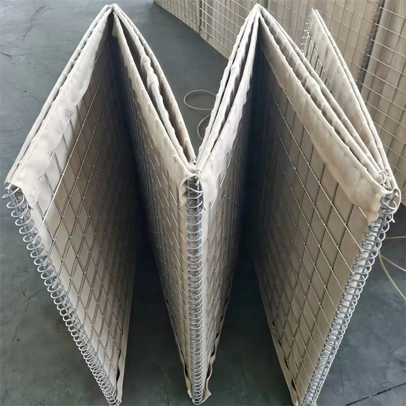 Stacked Hesco barriers featuring heavy-duty galvanized welded wire mesh and reinforced fabric walls, manufactured by DB Fencing for site security and crowd control.