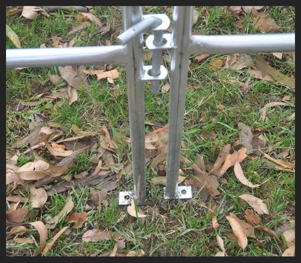 Close-up of hot-dip galvanised cattle panels with heavy-duty base mounting feet on grass
