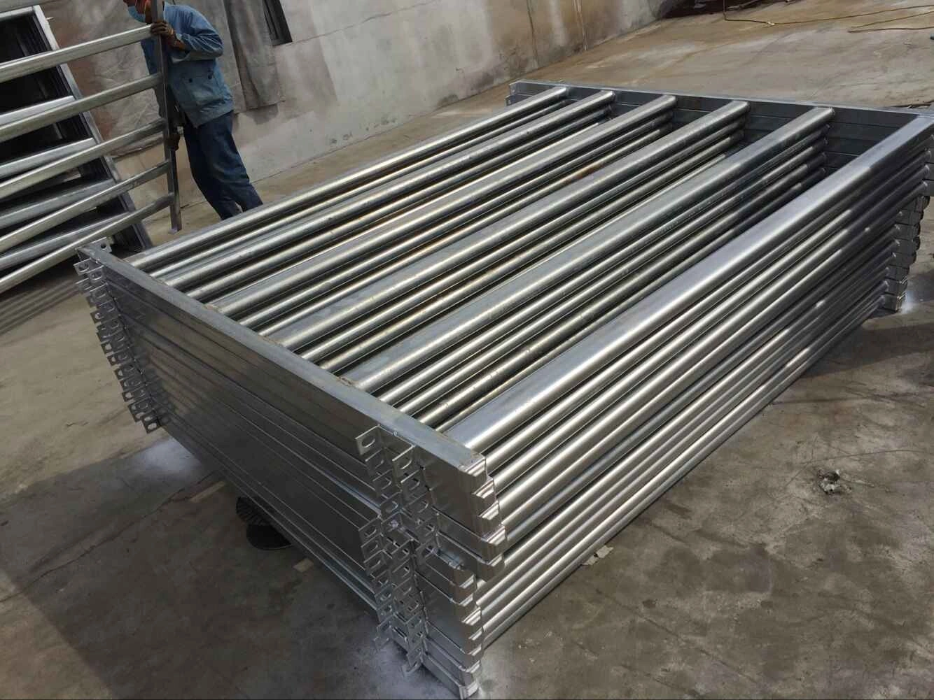Stacks of factory-direct hot-dipped galvanized cattle panels manufactured by DB Fencing, engineered for durable agricultural corral and livestock containment applications.