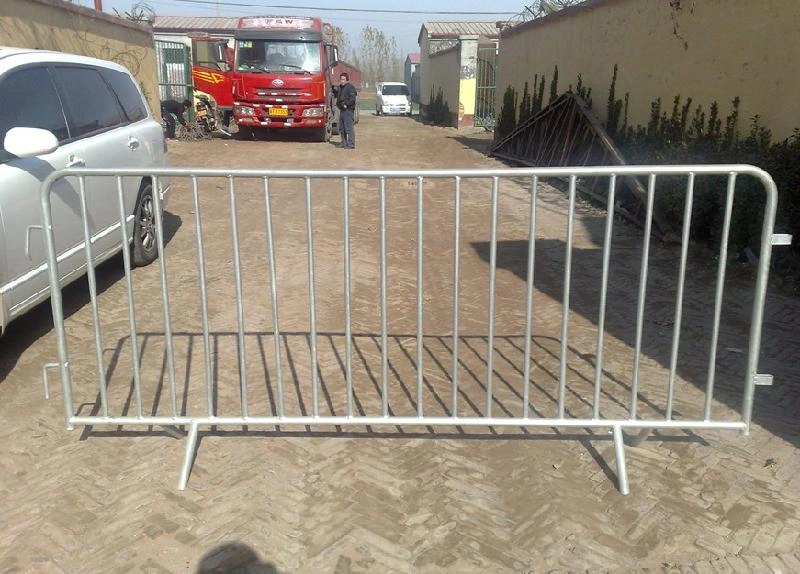 A robust, hot-dipped galvanized steel crowd control barrier, manufactured by DB Fencing, stands in a yard, demonstrating its readiness for event management and public safety applications. This temporary fencing solution exemplifies DB Fencing's commitment to producing durable, high-quality barriers designed to withstand harsh outdoor environments.
