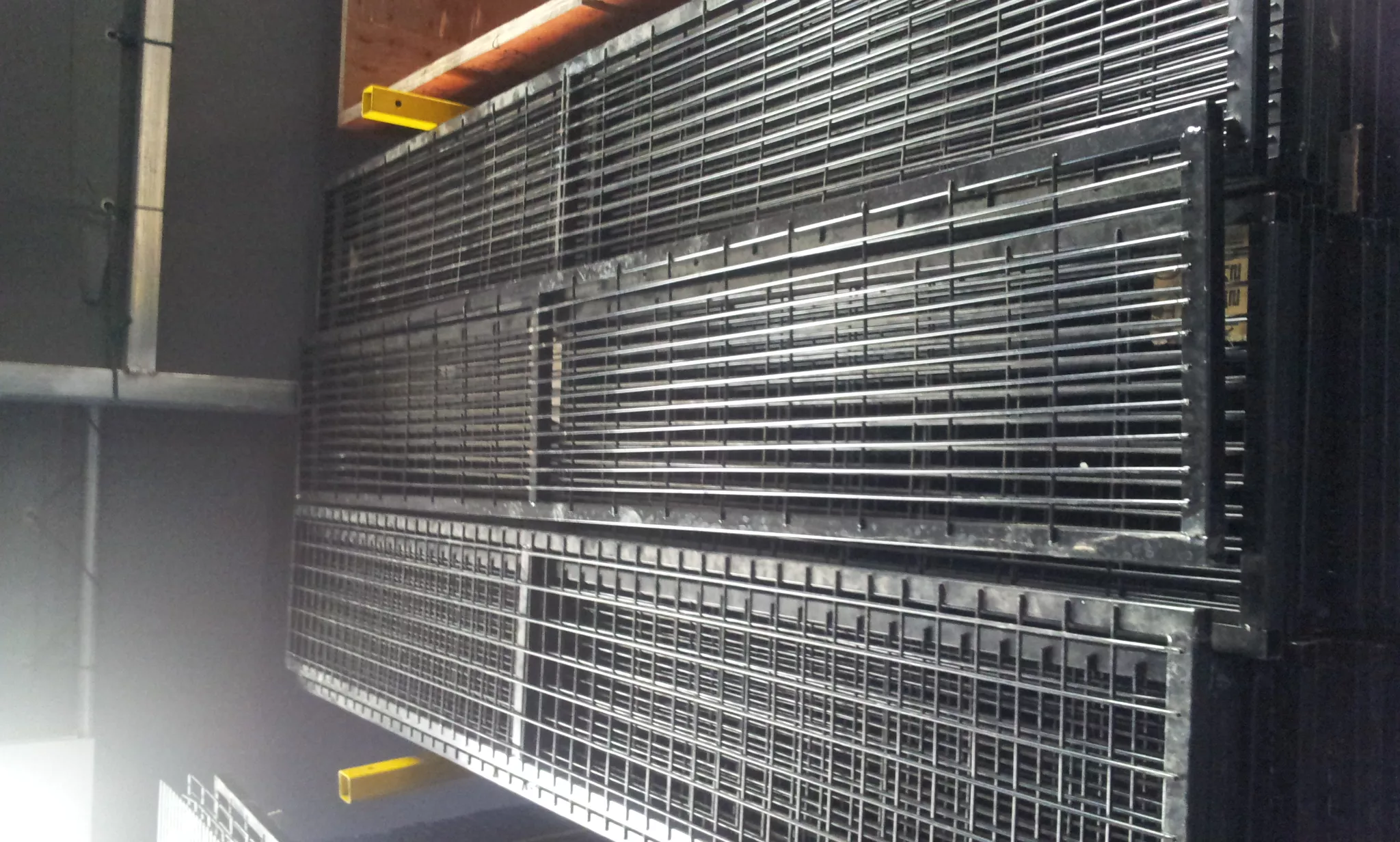 Stacks of heavy-duty galvanized steel welded mesh panels representing high-quality temporary fencing systems and permanent security fencing for construction sites.