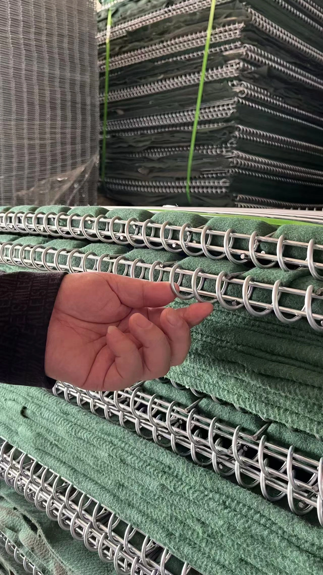 Close-up view of stacked PVC-coated Hesco barriers manufactured by Anping Deban Metal Wire Mesh Products Co., Ltd, designed for robust temporary site security and crowd control.