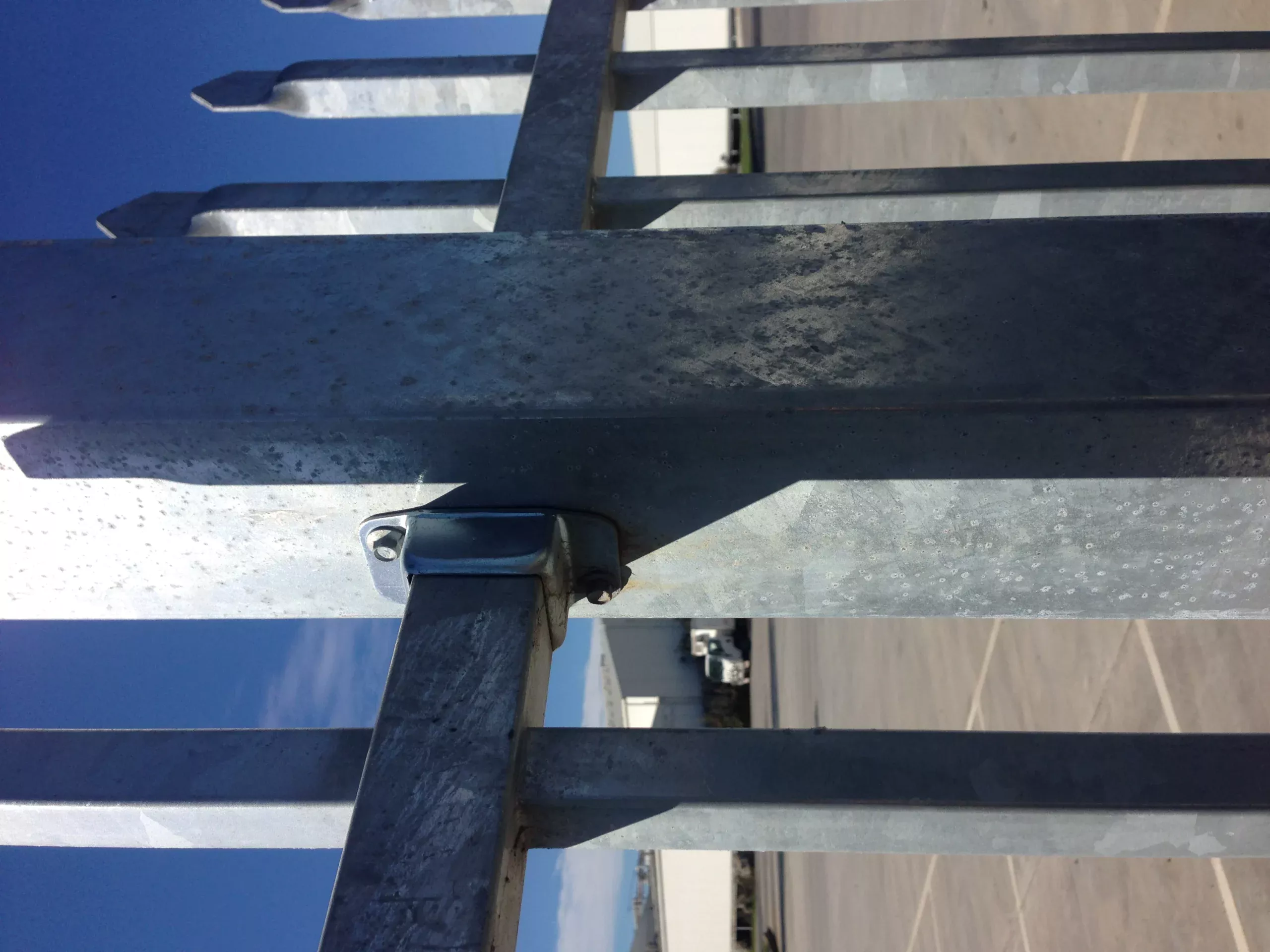 Close-up view of a heavy-duty steel picket fence manufactured by DB Fencing, featuring a hot-dipped galvanized finish exceeding 42 microns for superior corrosion resistance and long-lasting perimeter security.