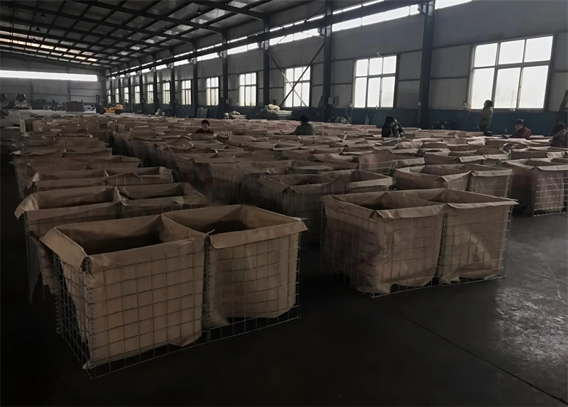 A panoramic view of rows of industrial Hesco Barriers in wire mesh cages, showcasing mass production capabilities by DB Fencing for bulk export. This scene highlights our manufacturing strength with 2,000 sets of temporary fencing and containment systems produced weekly.