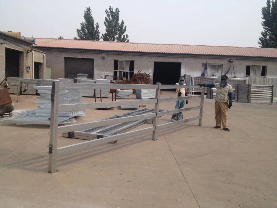 Workers welding fence panel frames on a production line