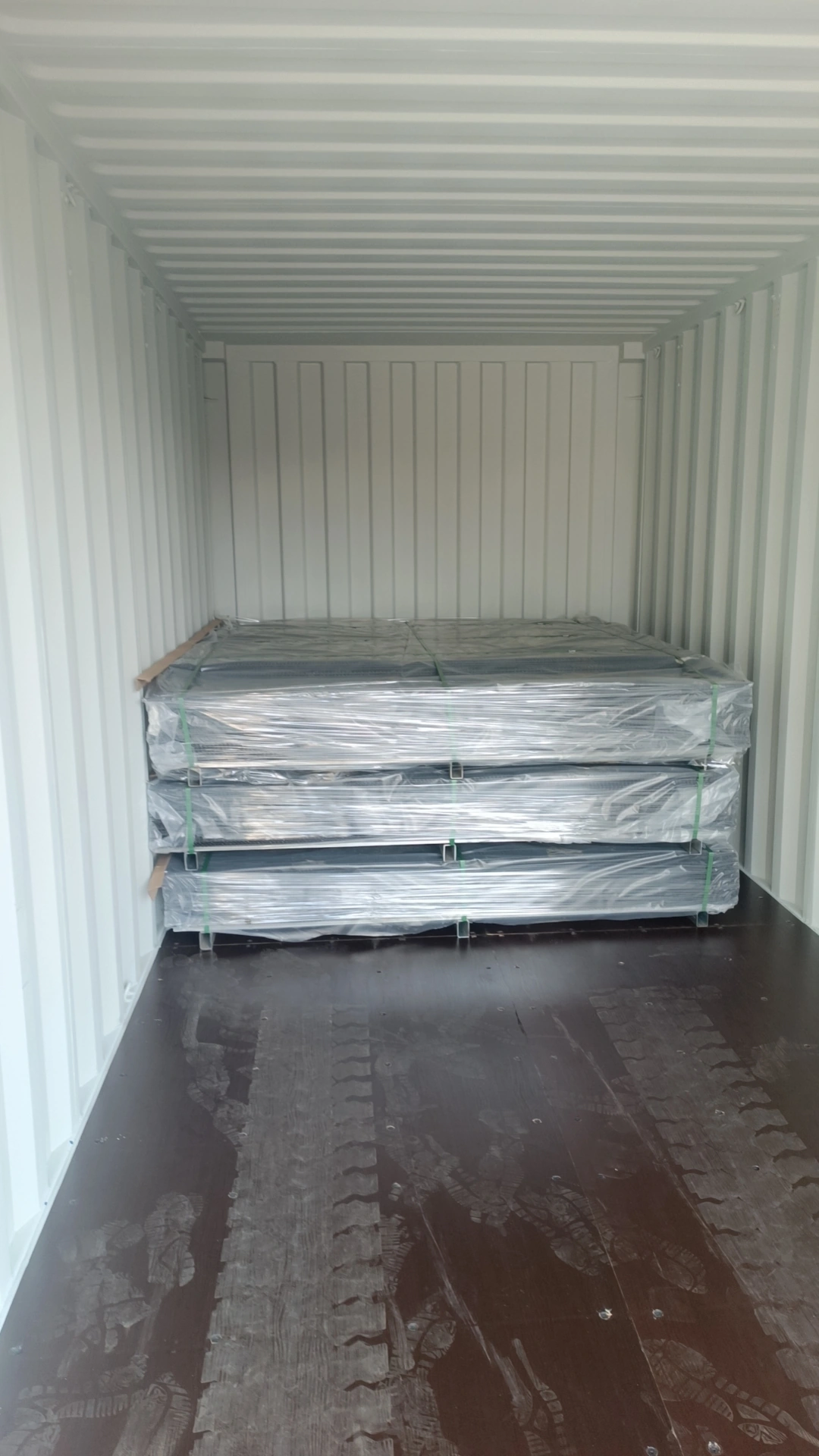 DB Fencing ships high-density steel security fencing, including heavy-duty cattle panels and galvanized Hesco barriers, securely loaded in shipping containers for global distribution.