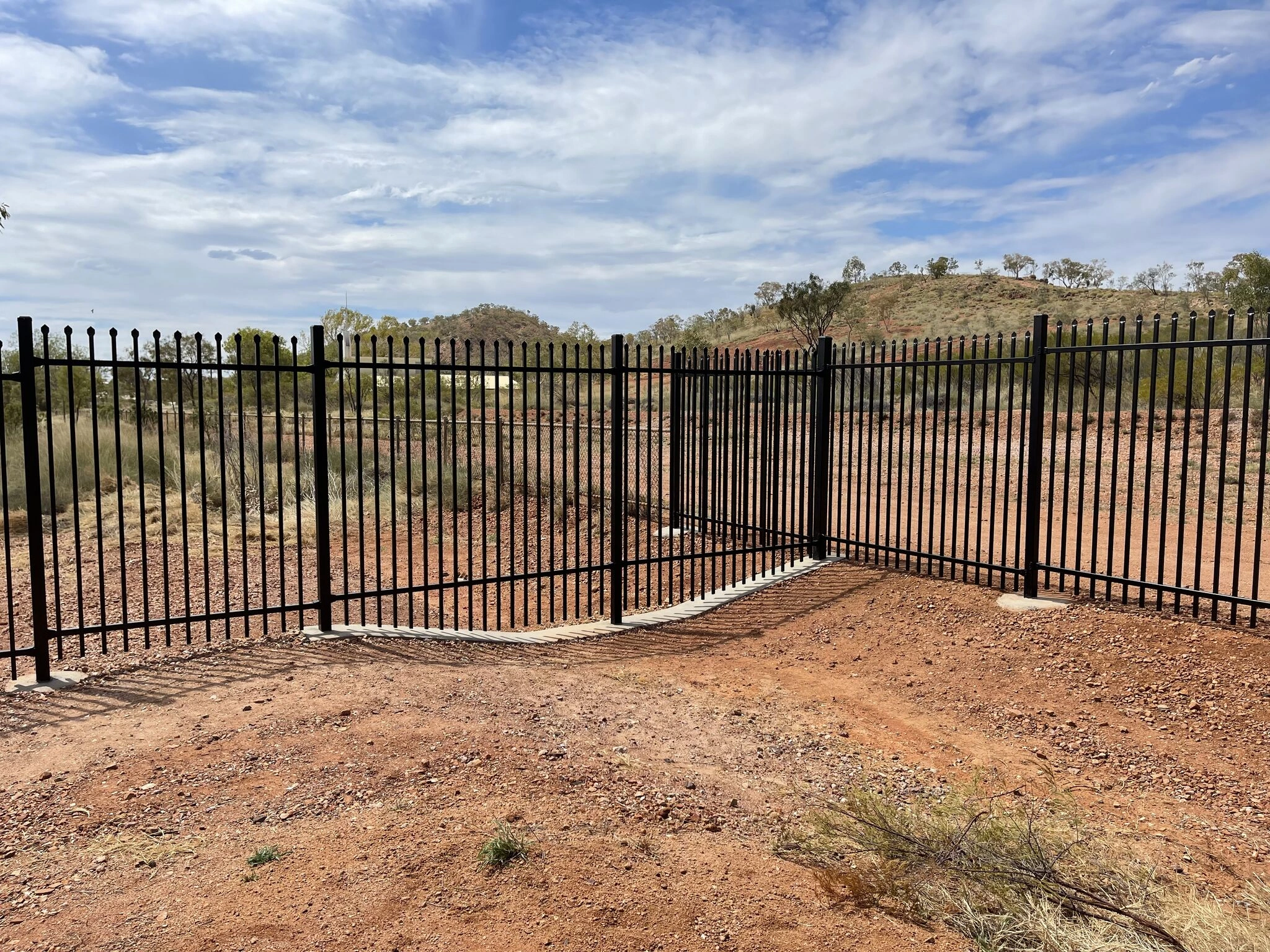 DB Fencing supplies permanent security fencing solutions featuring heavy-duty black steel picket panels installed on concrete footings in rural Australian terrain. Compliant with AS 4687, our factory-direct fencing provides a robust perimeter for commercial and agricultural properties.