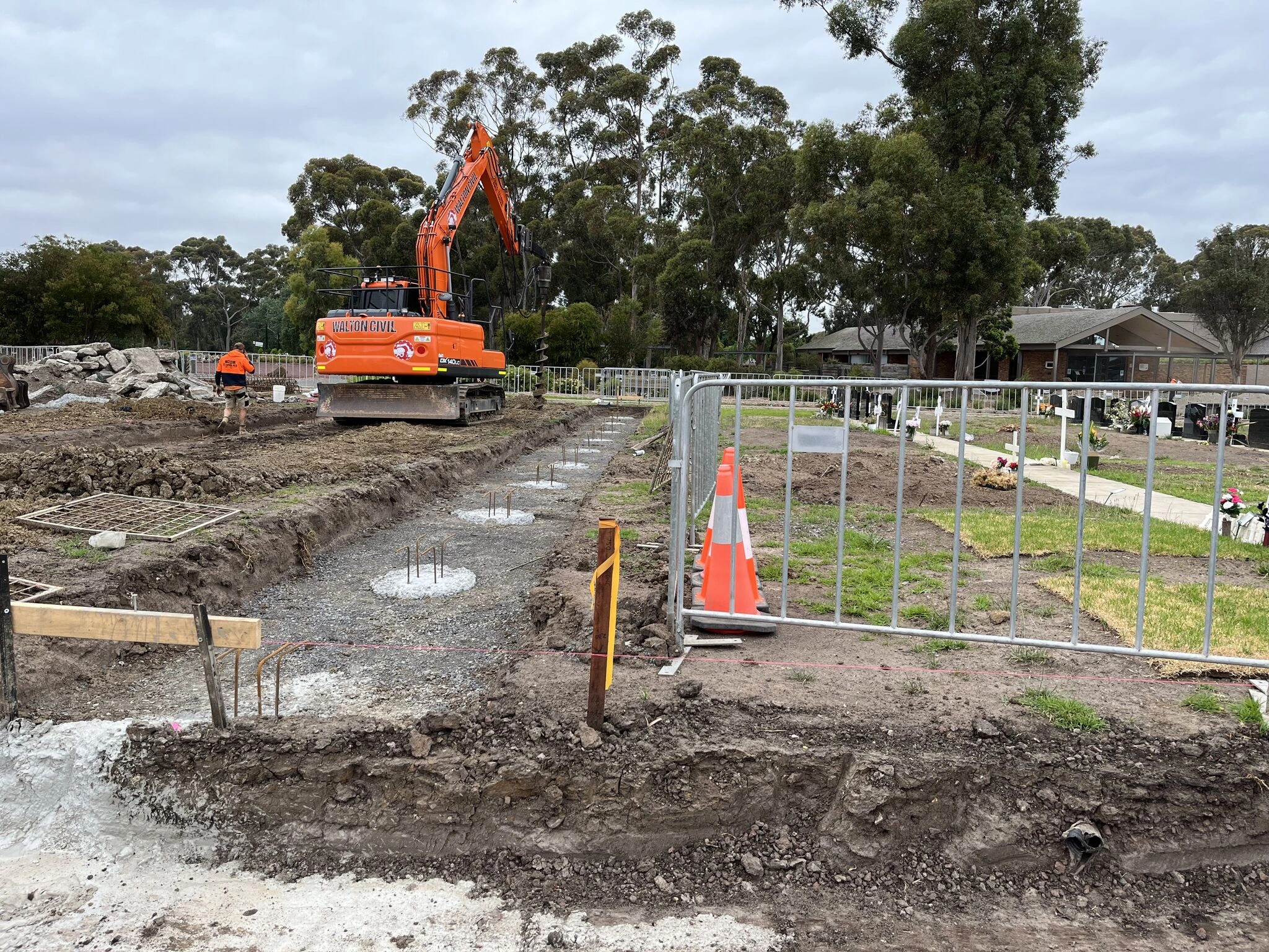 DB Fencing provides compliant and durable Temporary Fencing Systems for Construction Sites, as shown here demarcating an active excavation area with an excavator and new concrete footings. Our robust temporary fence panels ensure site security and public safety, meeting the needs of construction and civil engineering firms.