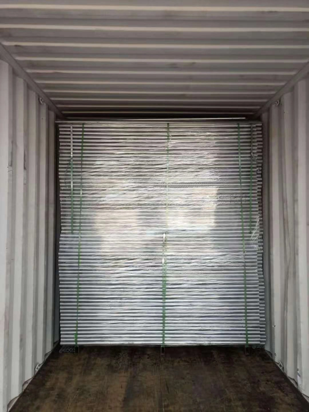 Galvanized temporary fencing systems for construction sites, securely bundled and loaded into a shipping container by DB Fencing for international export. This showcases our robust packaging and efficient bulk delivery of compliant, factory-direct temporary fence solutions to our global B2B clients.