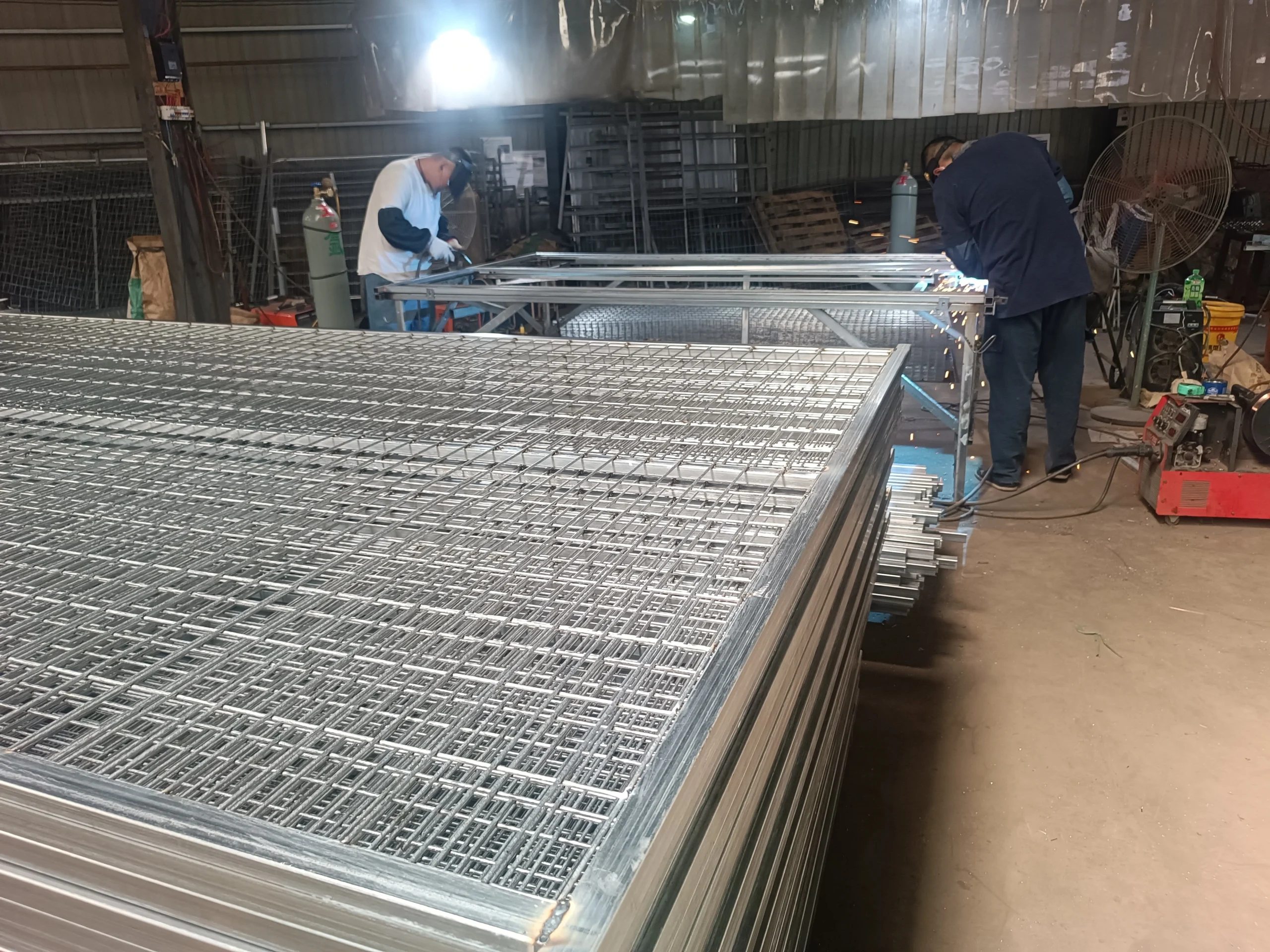 DB Fencing workers assemble heavy-duty temporary fencing systems for construction sites on an automated welding line, ensuring compliance for Australian and global markets.